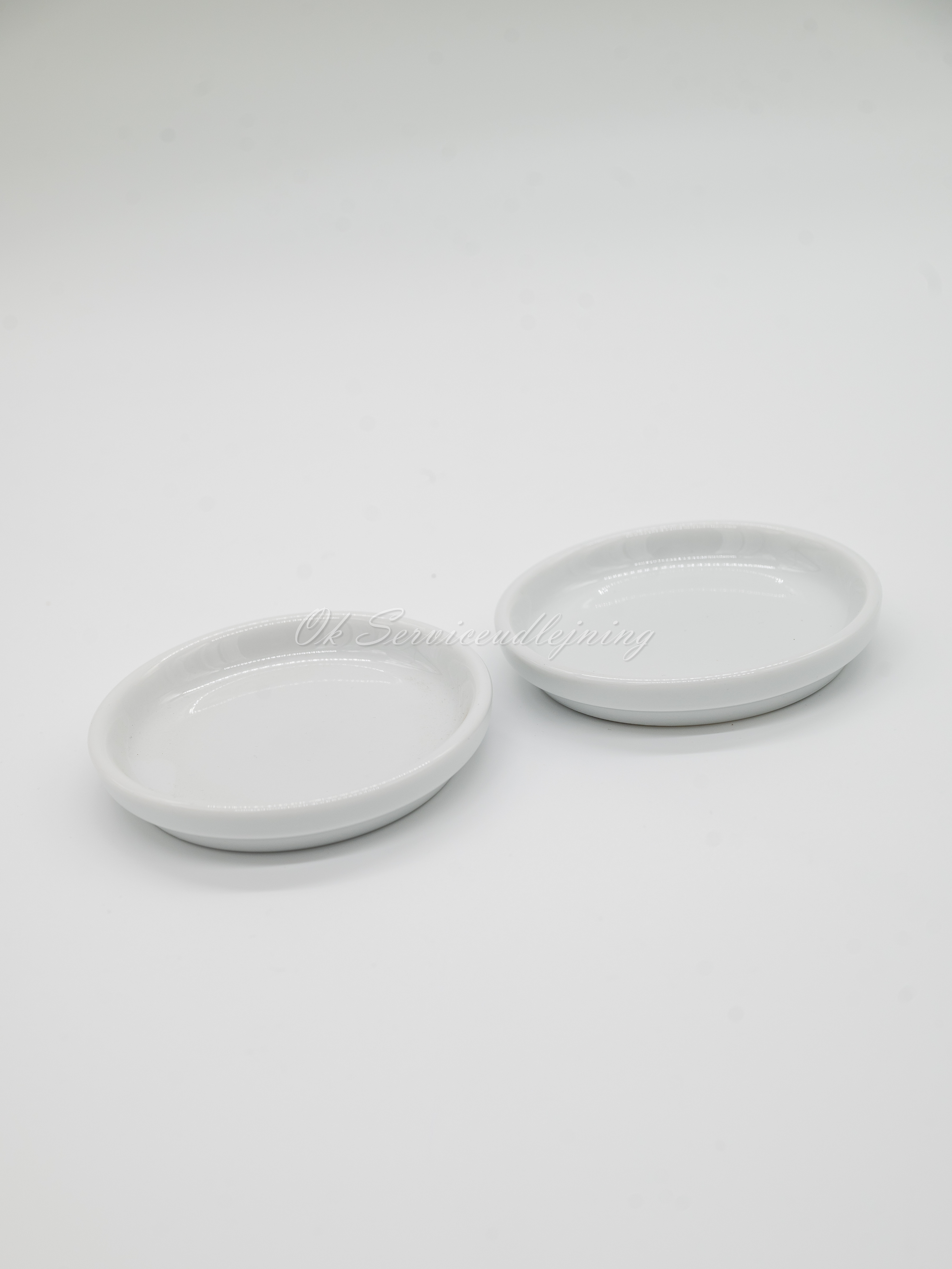 Eight shirts arranged on table in black, olive, grey, blue, white, red, mustard, and green.