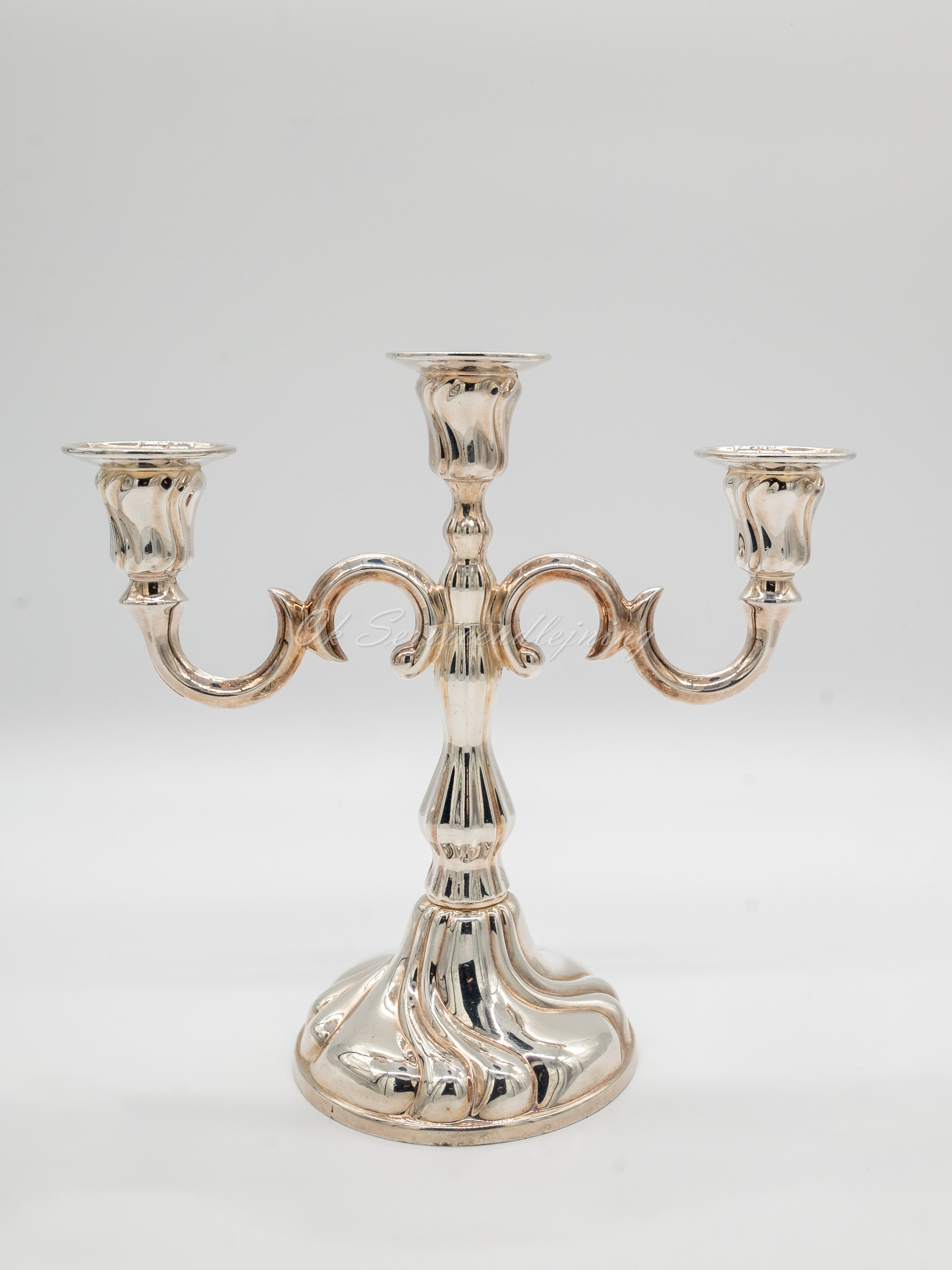 Eight shirts arranged on table in black, olive, grey, blue, white, red, mustard, and green.