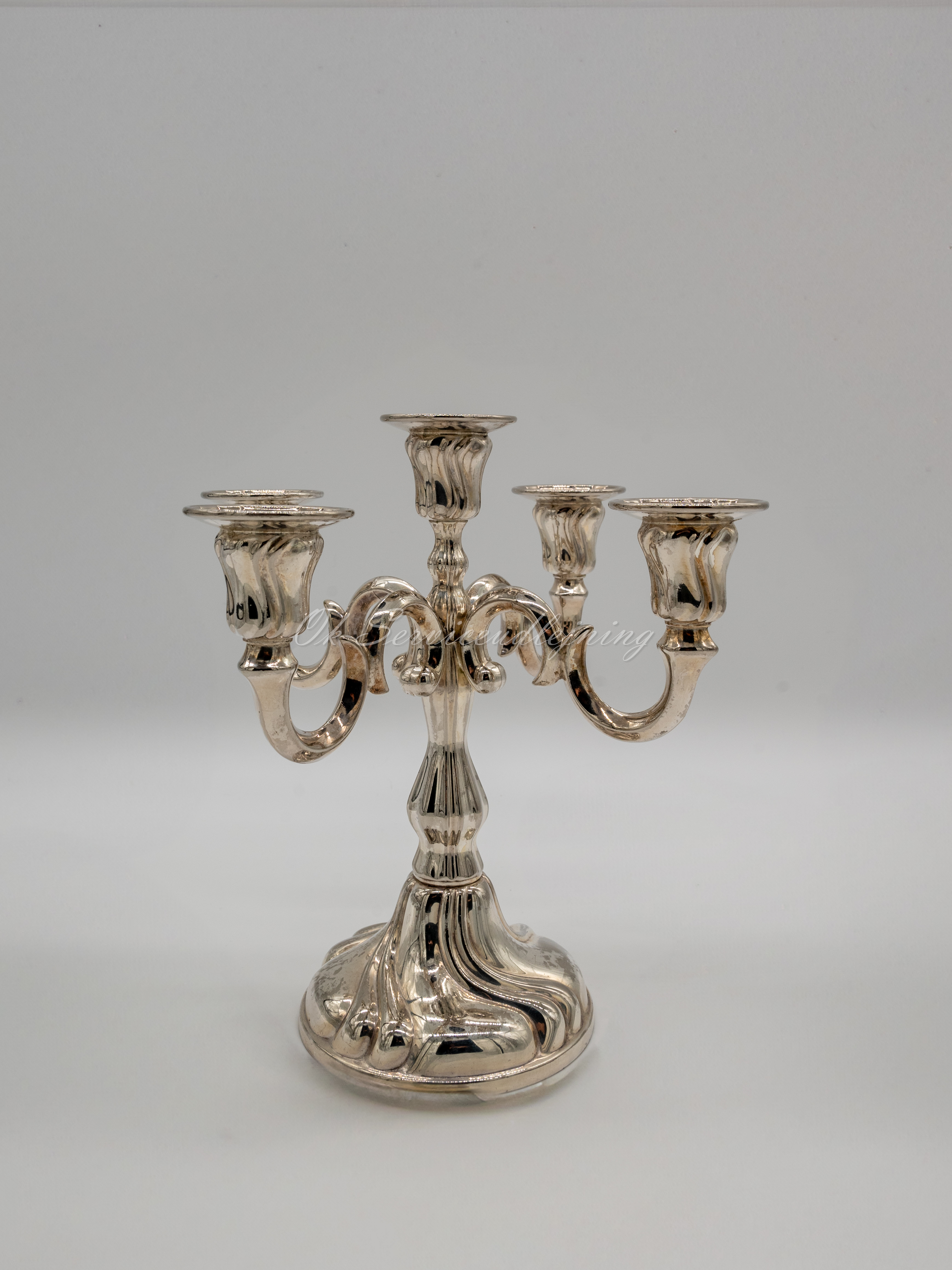 Eight shirts arranged on table in black, olive, grey, blue, white, red, mustard, and green.