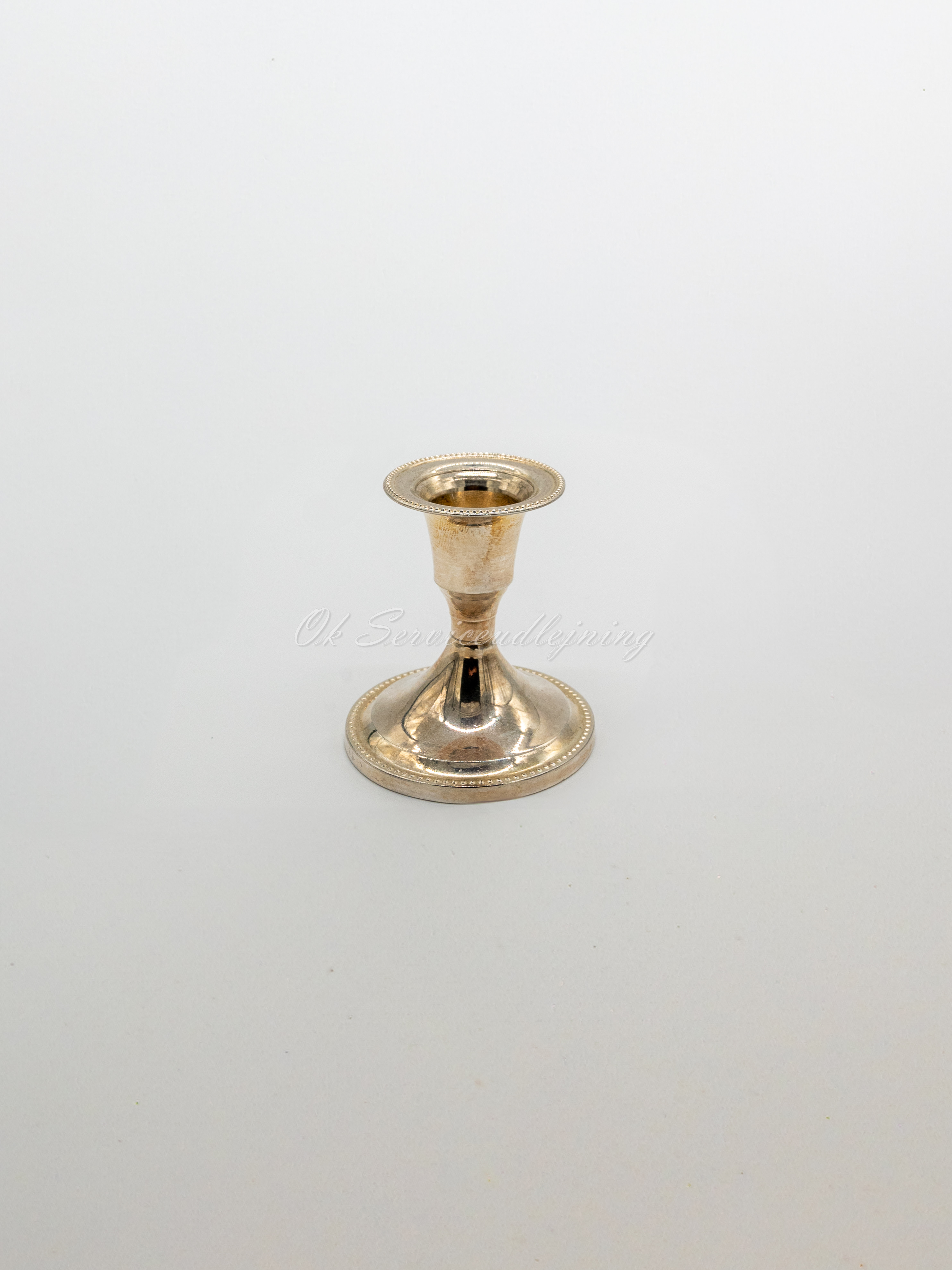 Eight shirts arranged on table in black, olive, grey, blue, white, red, mustard, and green.