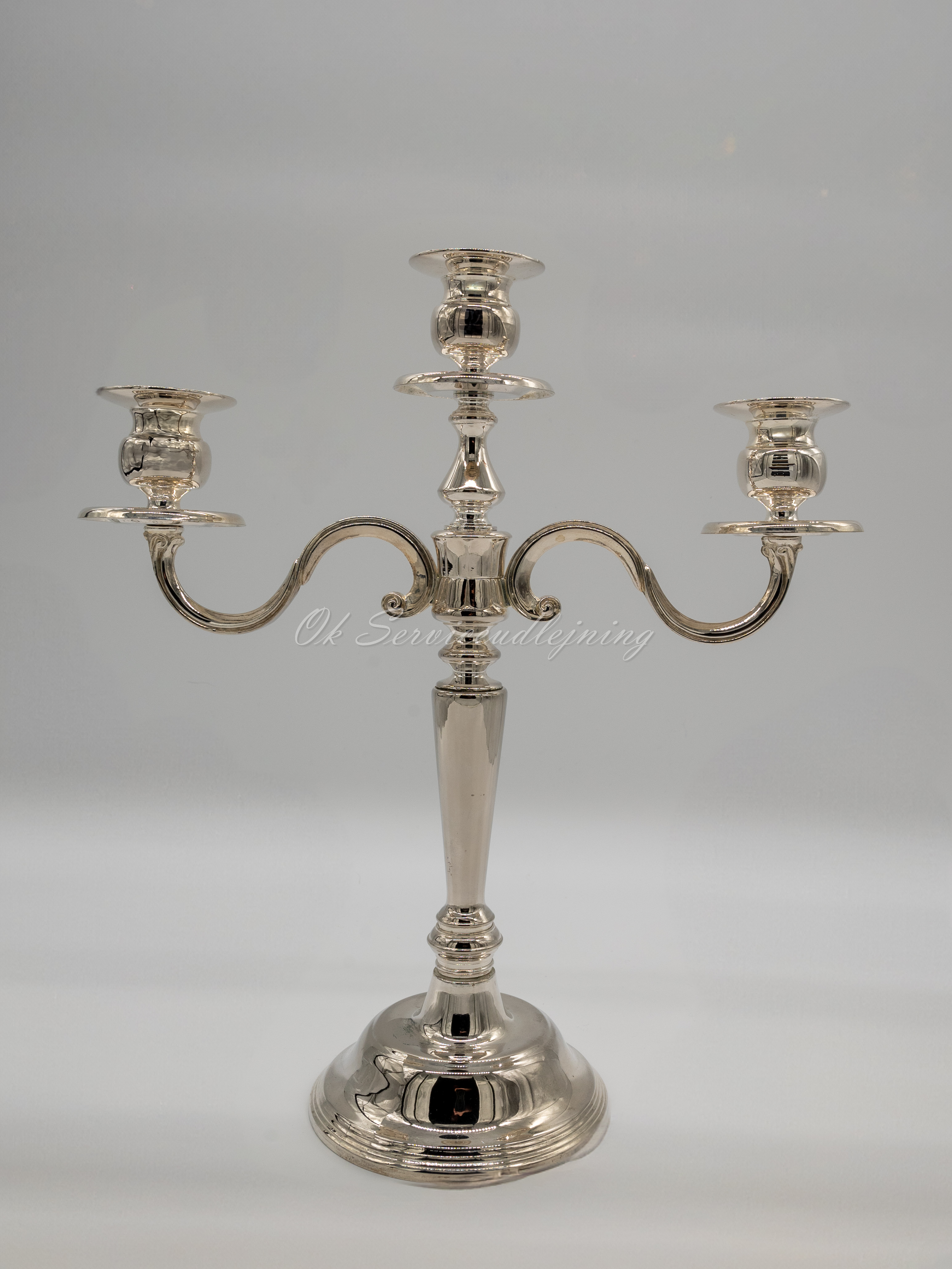 Eight shirts arranged on table in black, olive, grey, blue, white, red, mustard, and green.