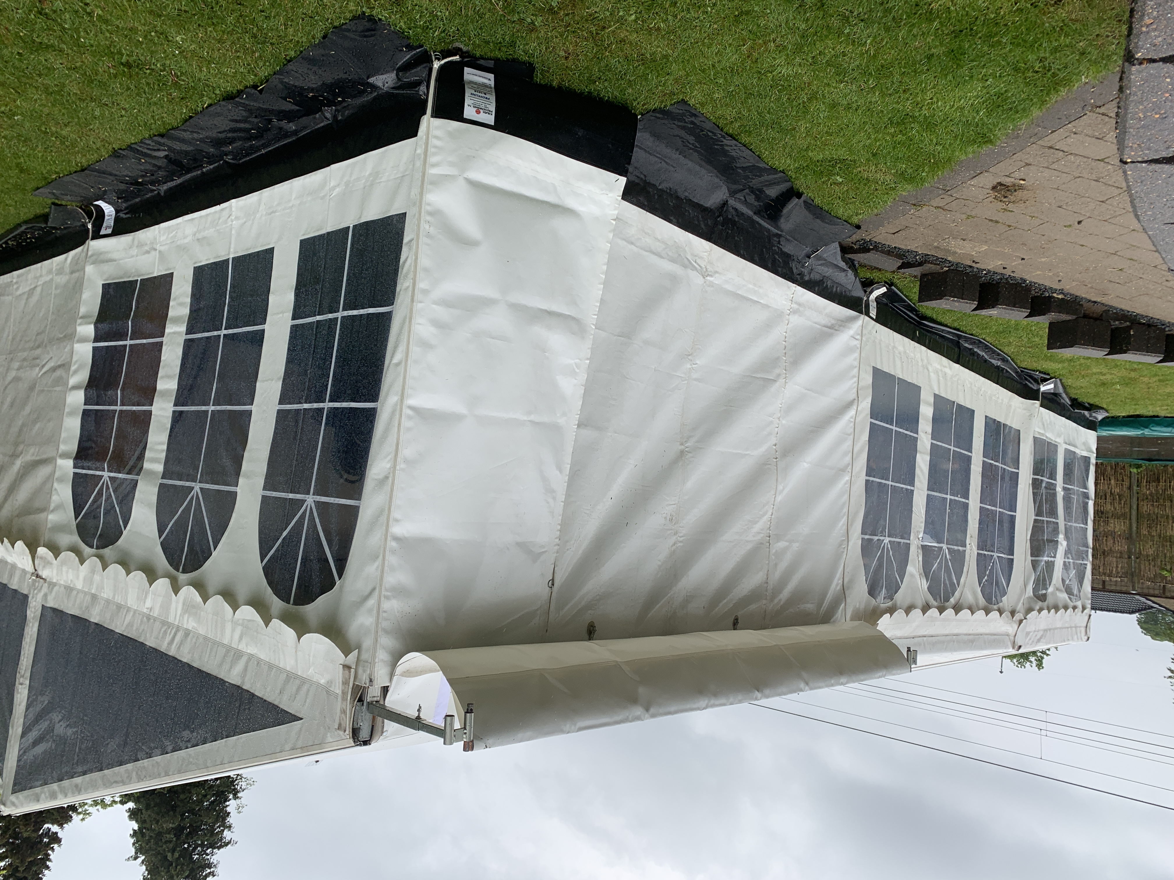 Eight shirts arranged on table in black, olive, grey, blue, white, red, mustard, and green.