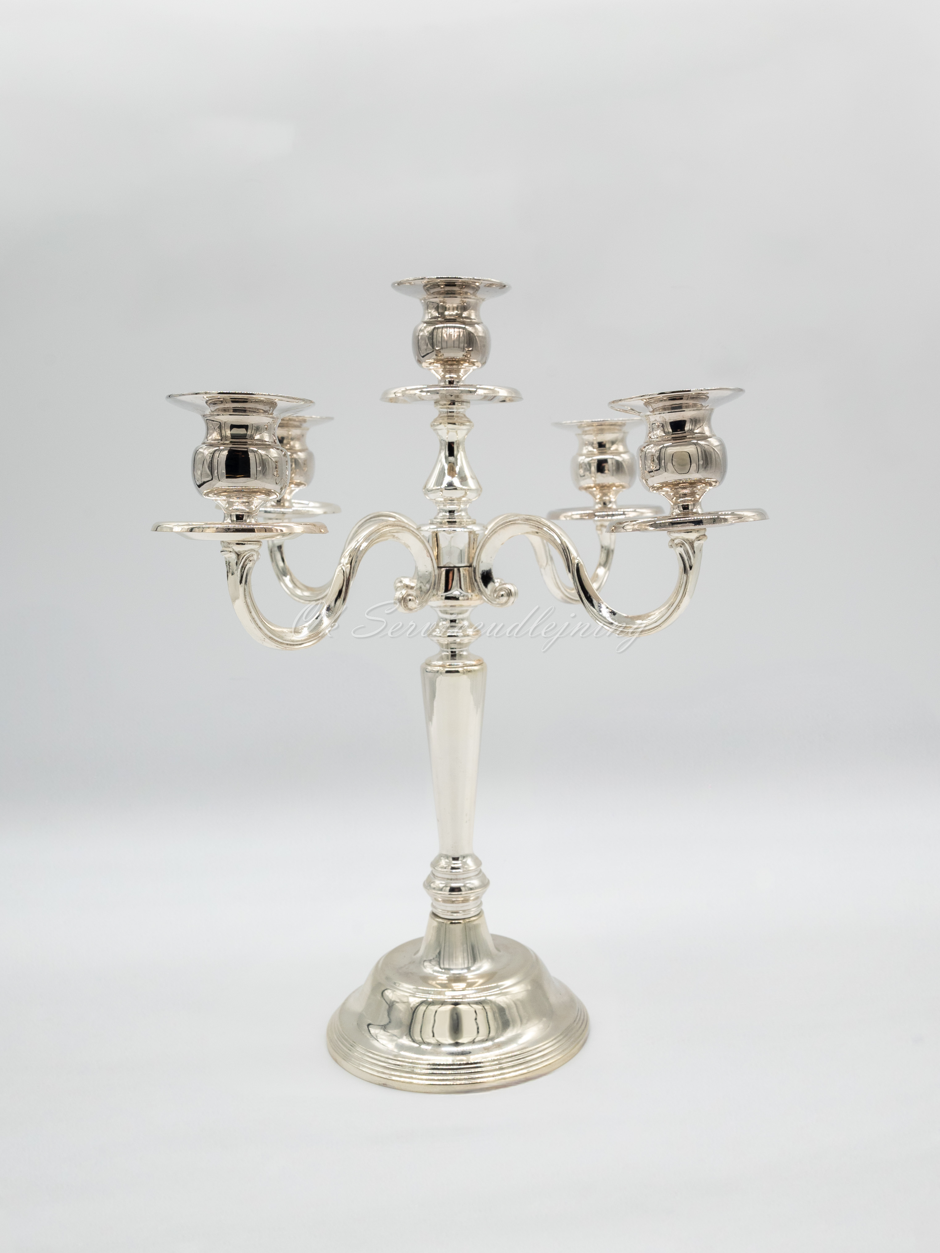 Eight shirts arranged on table in black, olive, grey, blue, white, red, mustard, and green.