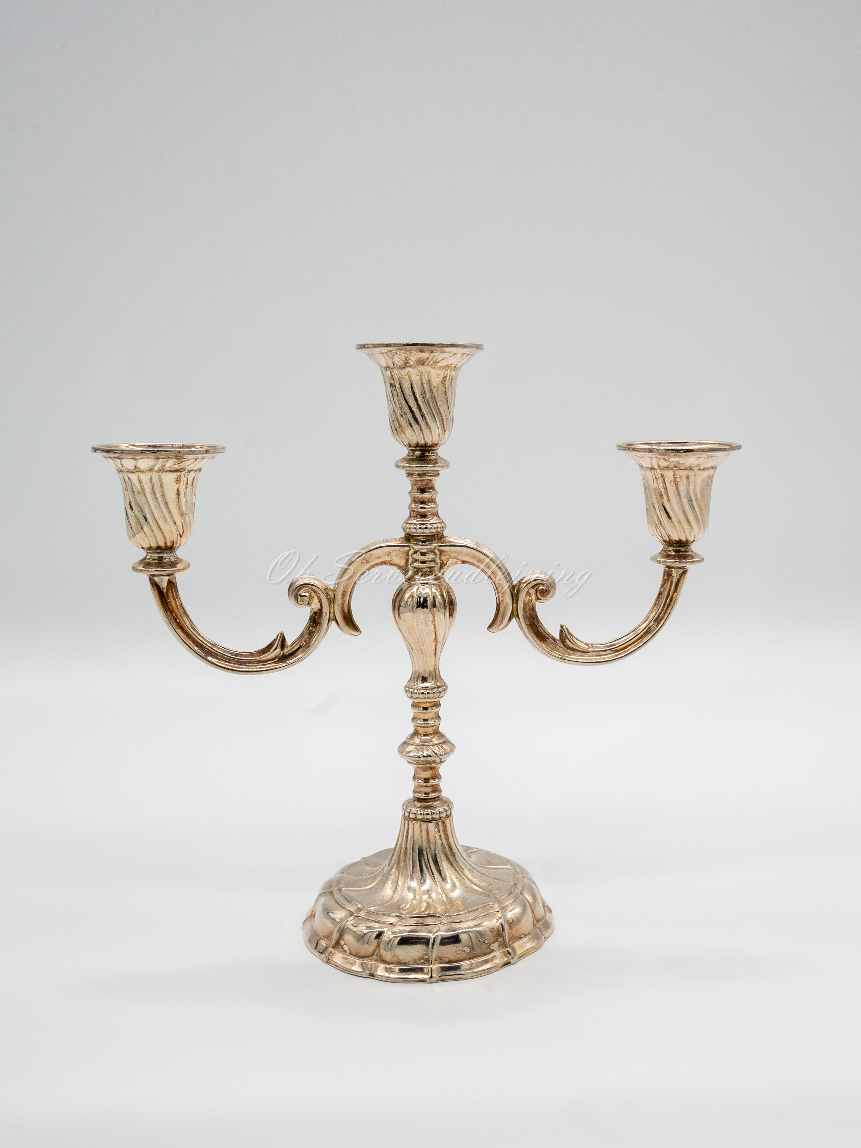 Eight shirts arranged on table in black, olive, grey, blue, white, red, mustard, and green.