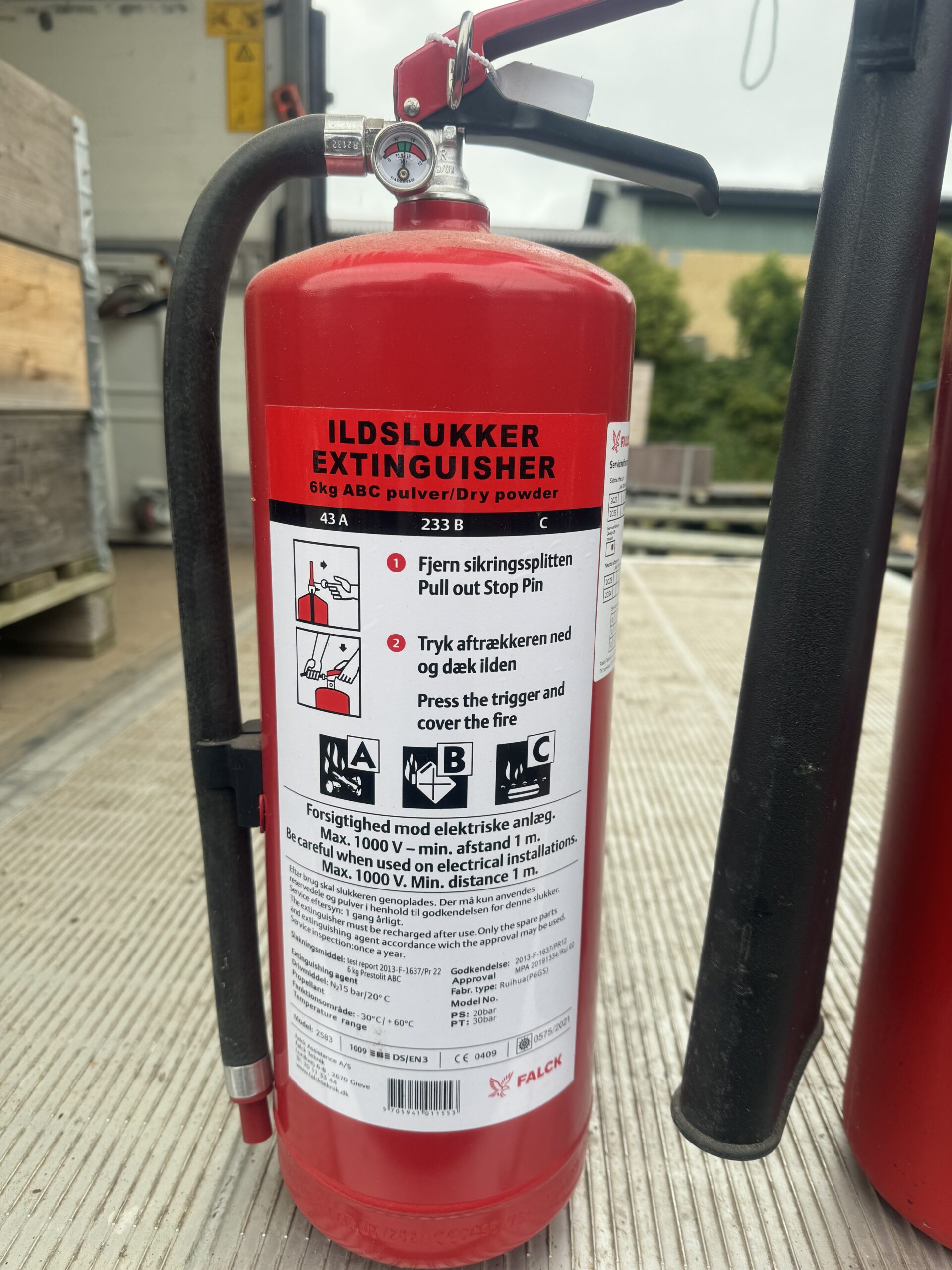 Eight shirts arranged on table in black, olive, grey, blue, white, red, mustard, and green.